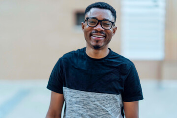 African man with glasses looking at camera smiling