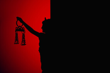 Silhouette of lady of justice on red background