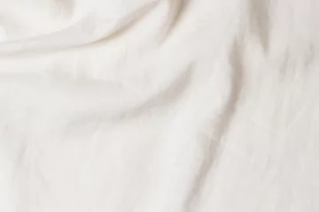 Rolgordijnen White crumpled linen fabric texture background. Natural linen organic eco textiles canvas background. Top view © vejaa