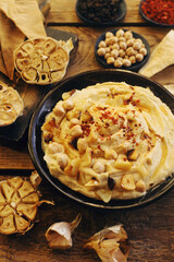 Traditional homemade middle eastern dish - hummus on rustic wooden table
