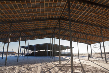 Timber frame roof construction in a barn under construction. Wooden roof frame.