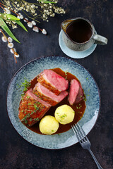 Traditional barbecue gourmet duck breast filet with skin served with potato dumplings in dark beer...