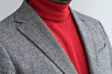 Close up of mens grey wool blazer combined with red fashionable sweater.  Selective focus.