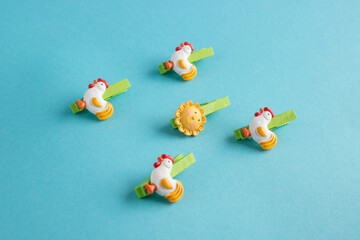 Five Easter clothespins on a blue background. Minimalistic Easter concept