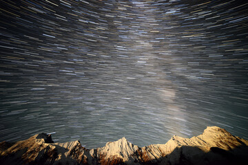 A composite image of milkyway and star trails over the nearby mountains of Hispar glacier in Karakoram range, Pakistan.