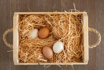 Basket of hay and fresh eggs 