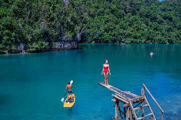 Sugba lagoon, tourists attraction. SUP Stand up paddle board. Blue sea lagoon, National Park, Siargao Island, Philippines.