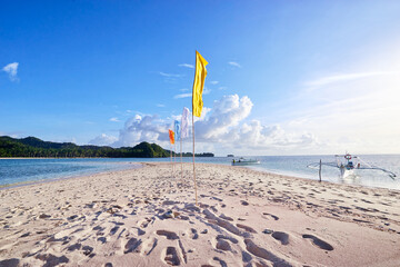 Beautiful landscape. White sand beach with colorful flags on it. Siargao Island, Philippines.