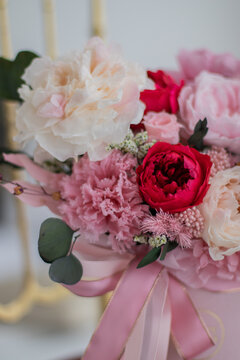 Bouquet of pink peonies a girl for mother's day, valentine's day, Woman's day 8 march. White interior.