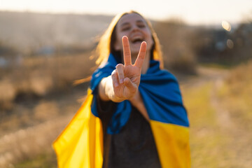 Cheerful ukrainian girl that shows a sign of peace or victory. Independence Day. Flag Day....