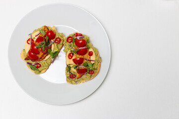 Healthy open vegan sandwich with avocado mash, zucchini, cherry tomatoes, cheese on top of corn bread. Healthy food, vegetarian food concept