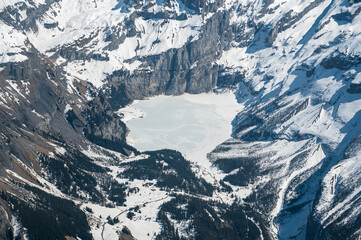 aerial view of still frozen Lake Oeschinensee in spring