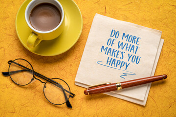 Do more of what makes you happy - inspirational handwriting on napkin, flat lay with coffee, happiness and personal development concept