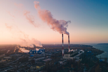 Factory smokestack emissions from manufacture using natural gas. Global energy crisis after Russia's invasion of Ukraine. Aerial view