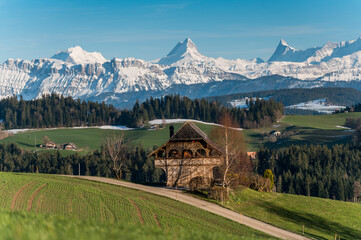 traditional Bernese farmhouse called Stöckli in front of the mighty Schreckhorn and Finsteraarhorn