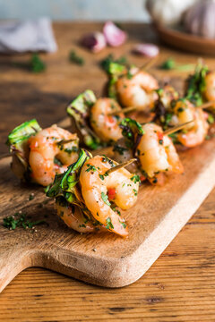 Chilli Garlic Prawns Starter on a wooden serving block