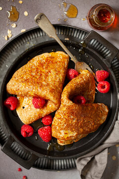 North Staffordshire Oatcake Pancake Served With Raspberries And Golden Syrup.