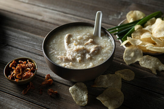 Steamy bowl of Chicken Jook in a rustic kitchen