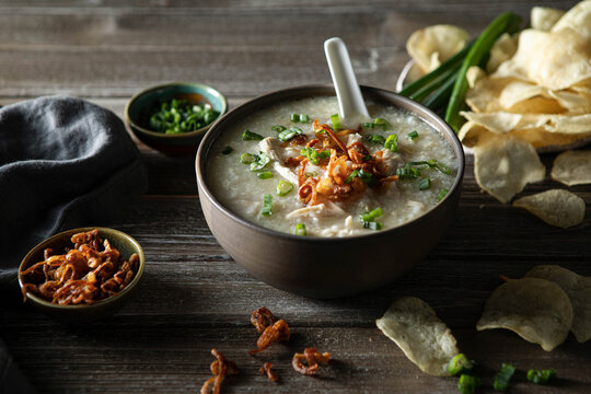 Steamy bowl of Chicken Jook in a rustic kitchen