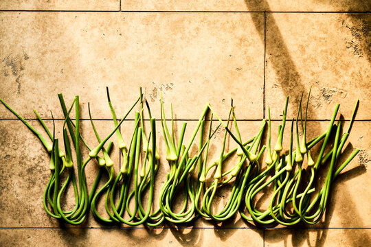 Green Garlic Scapes on tiles