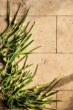 Green Garlic Scapes on tiles