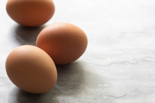 Three eggs on a marble background.