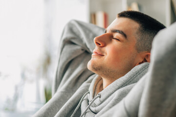relaxed young man at home on the sofa
