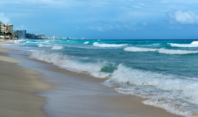 Sandy shore, beach and turquoise sea, big waves, Caribbean, Cancun, Yucatan, Mexico.