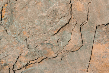 Stone background for manufacture of floor tiles. Textured stone art background in brown colors close-up.