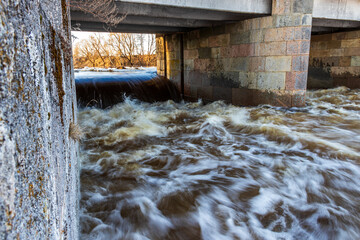 high water, dam under bridge