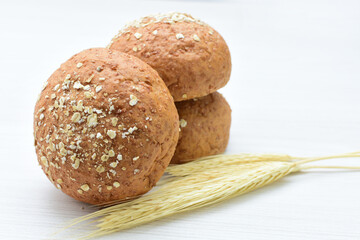 Round wholemeal oat bread, sweetened with natural panela, displayed on white wood