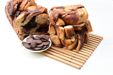Large chocolate artisan bread, extra chocolate displayed on white wood