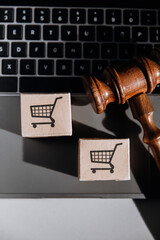 Judge gavel and card boxesx on a laptop. Vertical image. Consumer rights concept