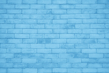 Brick wall painted with pale blue paint pastel calm tone texture background. Brickwork interior design element.
