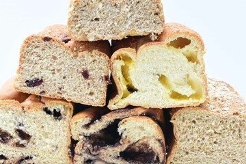 Mix of artisan breads of different natural flavors, displayed on a wooden background