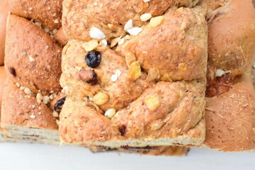 Mix of artisan breads of different natural flavors, displayed on a wooden background