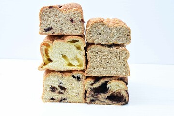 Mix of artisan breads of different natural flavors, displayed on a wooden background