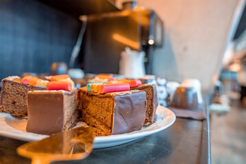 Assortment of fresh sweet cake slices in plate on counter at restaurant