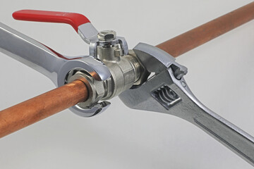 Wrenches, copper pipes and fittings.