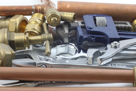 	Random mixture of copper pipe, tools and brass fittings .