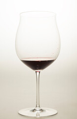 red wine in a special glass on a light background in a studio without people close-up