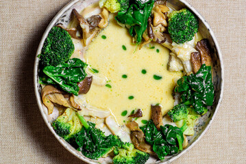 Bowl with delicious mushroom soup with cream and broccoli