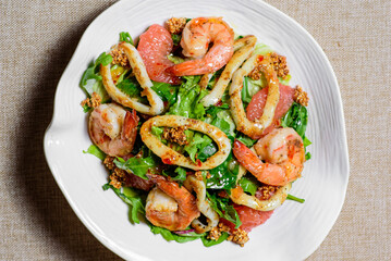 Fototapeta na wymiar Spicy squid and shrimp salad. Thai food, spicy octopus, squid salad.top view