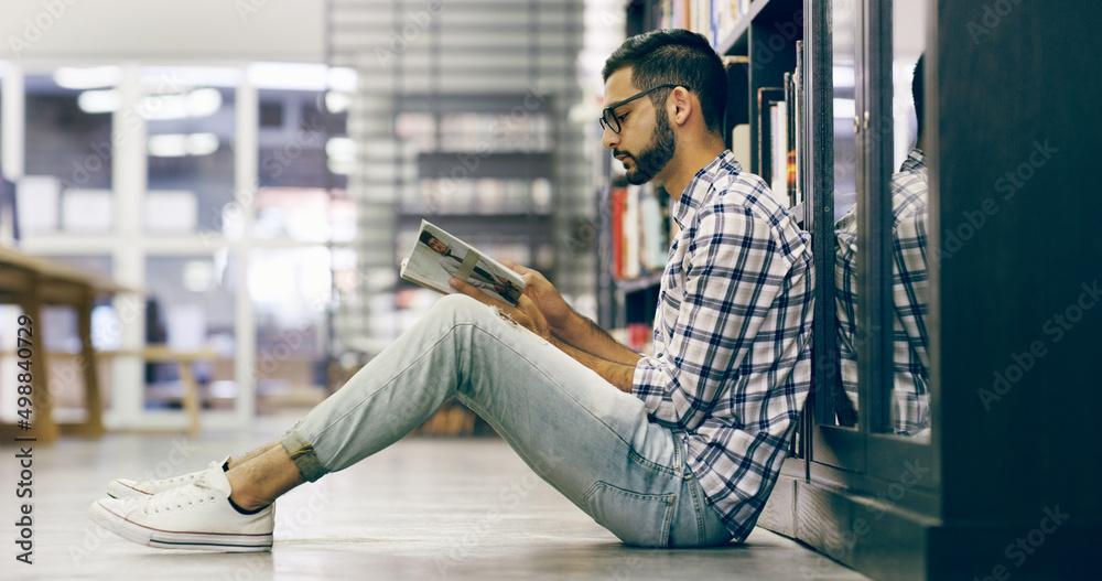 Aufkleber hes found a quiet place to study. full length shot of a handsome young university reading a book whi