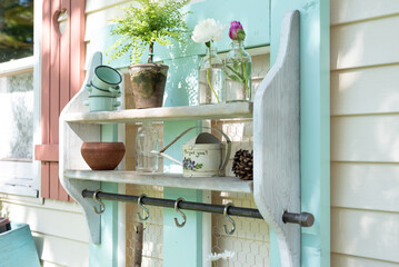 Outdoor shelves with potted plants and flower blossoms