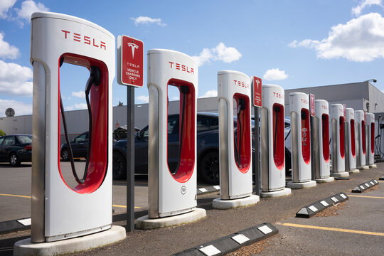 Salem, OR, USA - Apr 2, 2022: A Tesla Superchargers station in Salem, Oregon. Tesla, Inc. is an American automotive electric vehicle and clean energy company headquartered in Austin, Texas.