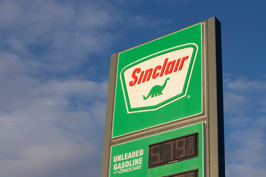 Williams, CA, USA - Mar 19, 2022: Closeup of the Sinclair sign seen at a Sinclair gas station in Williams, California. Sinclair Oil Corporation's logo features the silhouette of a green dinosaur.
