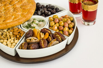 Traditional Ramadan iftar,beginning menu set with soup,olives,date fruit,nuts,red rose sherbet and  Ramadan Bread.