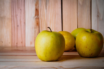 Green apples on a wooden background. Still life in rustic style.