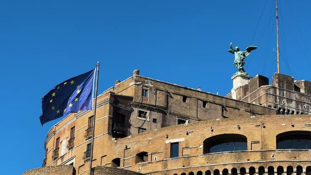 Slowly waving european flag on Mausoleum of Hadrian against blue sky in Rome,Italy